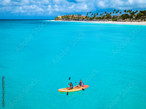 Fototapeta Naklejka Na Ścianę i Meble -  Couple Kayaking in the Ocean on Vacation Aruba Caribbean sea