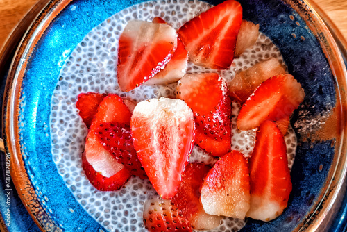 Bowl of chia pudding with fresh strawberries close up