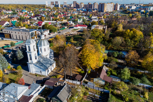 Scenic panoramic view of the countryside with a white stone temple in honor of Boris and Gleb from the 18th century, city outskirts. Obninsk, Russia photo