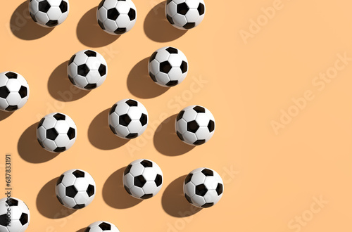 Classic black and white colored soccer balls on burlywood background