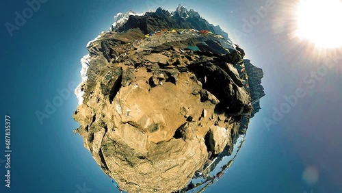 360 VR Gokyo Ri mountain top. Tibetan prayer Buddhist flag. Wild Himalayas high altitude nature and mount valley. Rocky slopes covered with snow. Tiny planet transformation. photo