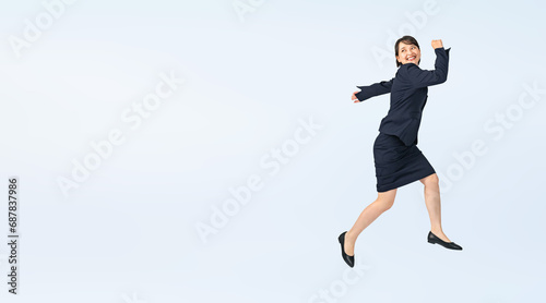 ジャンプするスーツを着た女性　切り抜き全身写真（切り抜き背景透過PNGも販売しております。作成者リンクから「PNG」で検索してください） photo