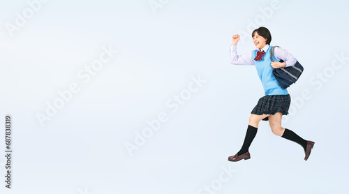 ジャンプする制服を着た女子学生　切り抜き全身写真（切り抜き背景透過PNGも販売しております。作成者リンクから「PNG」で検索してください） © metamorworks