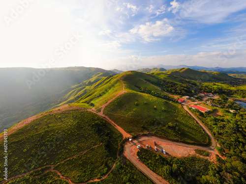 aerial view on the peak in sunset the village far from civilization Traveling on a difficult road. Beautiful sunset view on the hilltop complex. The sun shone through mountain peak after mountain. photo