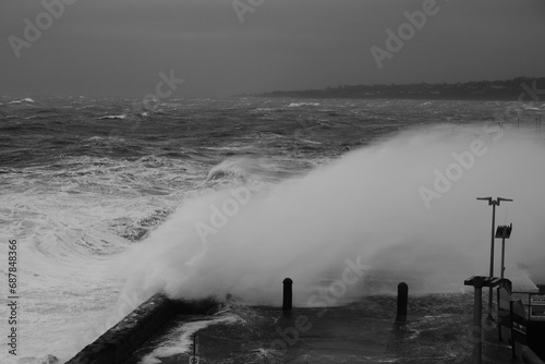 Giant Waves Crashing Over Mornington Jetty. Mornington Pier is a popular destination for a range of recreational activities including sightseeing, fishing and scuba diving.