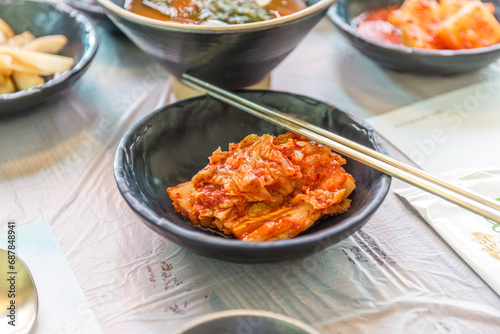 Closed up of Kimchi cabbage in a bowl with stainless steel chopsticks, Korean food