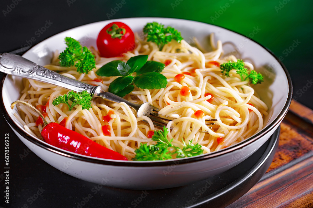 Pasta, spaghetti in a plate with seasonings and vegetables. Hot, natural and tasty dish. Pasta, spaghetti in a plate with seasonings and vegetables. Hot, natural and tasty dish.