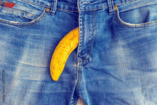 Potency problem concept.Mens denim pants with banana and lemons imitating male genitals.Health and male sexuality concept.Closeup.