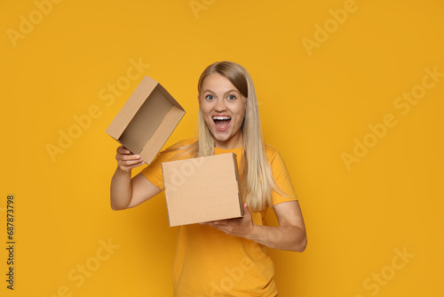 An attractive blonde looks into a cardboard box
