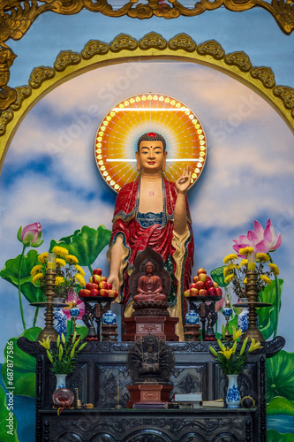 Statue of Hindu Deity overlooking an Asian, religous shrine. photo