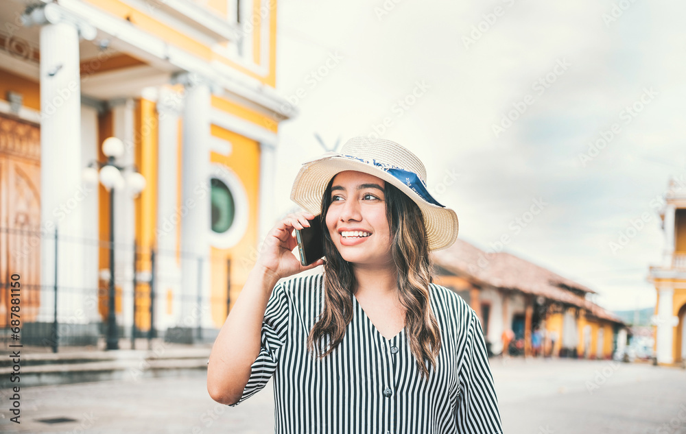 Tourist girl calling phone in the street. Happy travel woman calling on the phone in a tourist plaza Tourist girl calling phone in the street. Happy travel woman calling on the phone in a tourist plaza