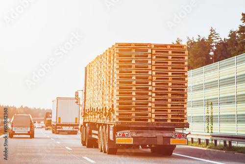 A Truck transporting a European pallet load on the highway. Truck Carrying European Pallet Load on the Road. photo
