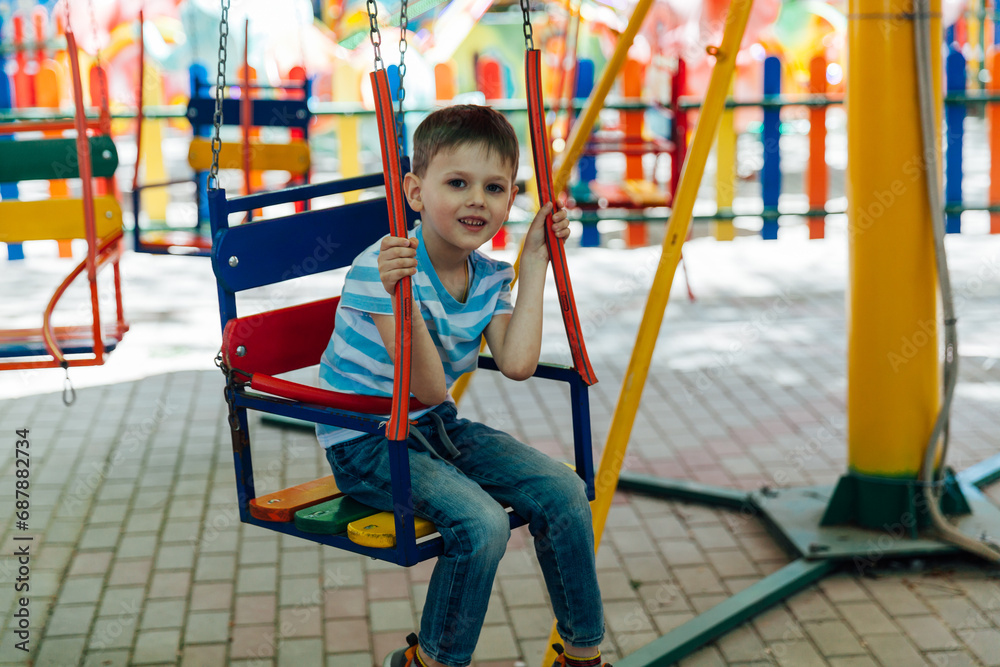 rides children's swing boy rides on a merry-go-round rides children's swing boy rides on a merry-go-round