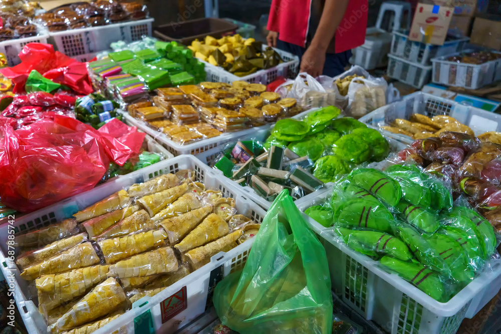 Many varieties of traditional snacks sold in the Marketplace in dawn time in Surabaya, East Java, Indonesia.