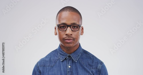 Serious man, glasses and face of nerd or geek standing isolated against a studio background. Portrait of smart male person or casual model looking with spectacles, blank stare or eyewear on mockup photo