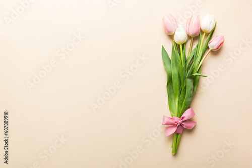 Bouquet of pink tulips on colored table background . Top view with copy space. Waiting for spring. Happy Easter card. Flat lay © sosiukin
