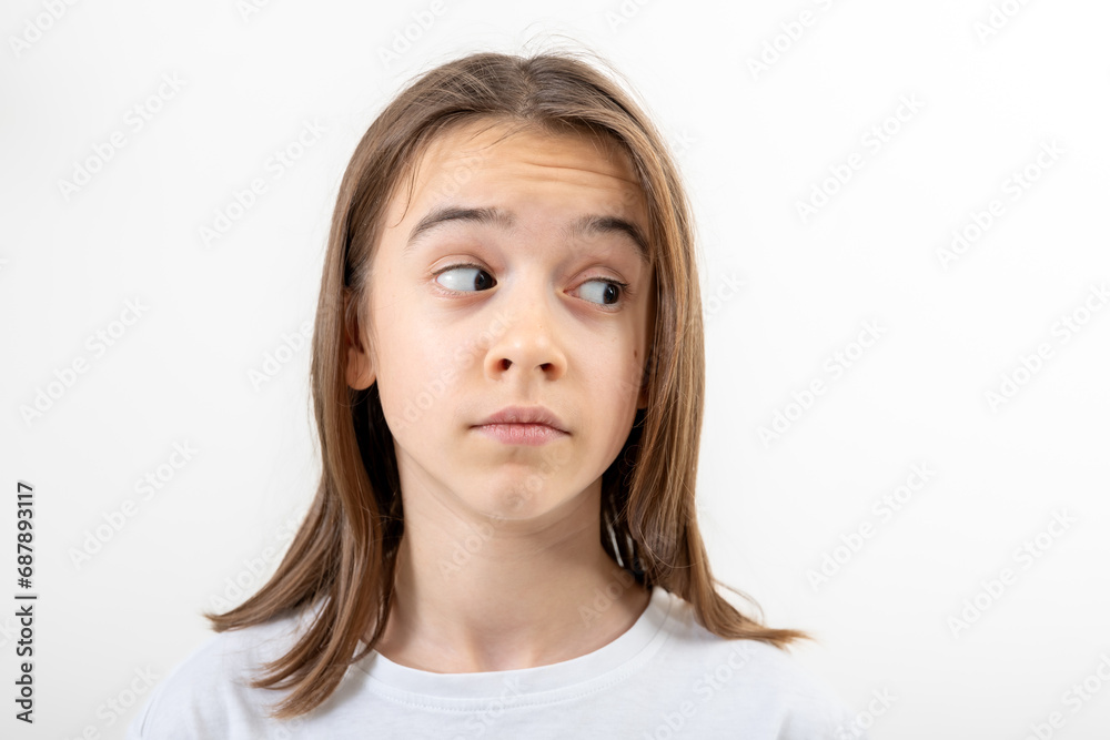 Little girl looks to the side in surprise on a white background isolated. Little girl looks to the side in surprise on a white background isolated.