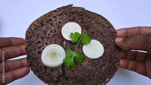 Eleusine coracana or finger millet chapati. Its other names Ragi and madua in India and Kodo in Nepal. Indian Traditional Ragi roti or flat bread. Madua roti or flat bread.  Shot on white background.
 photo