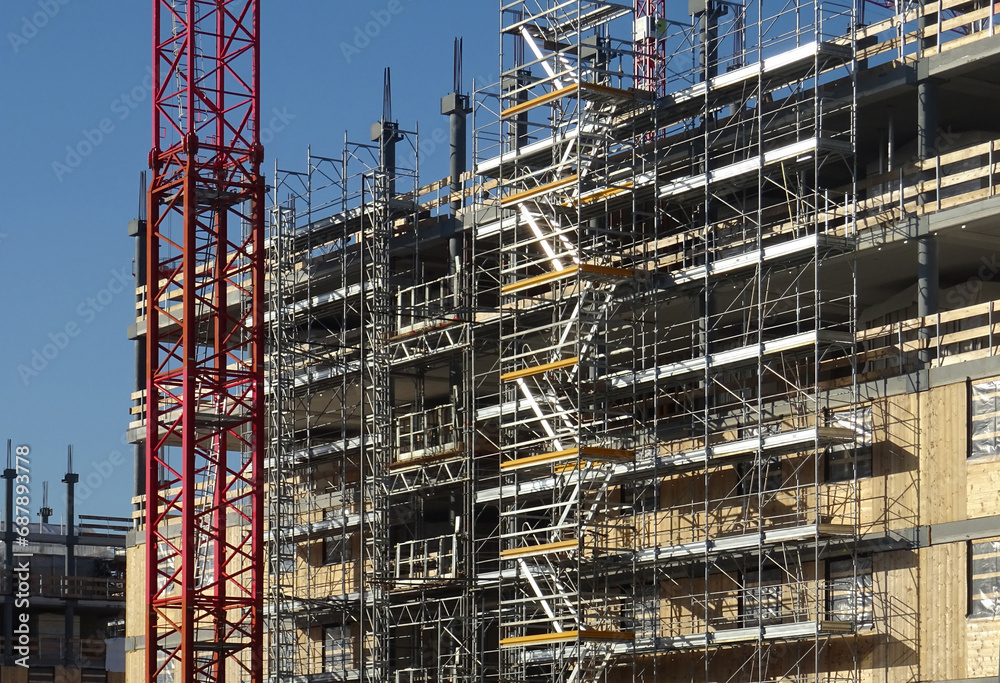 scaffolding on building under construction, external service staircases
