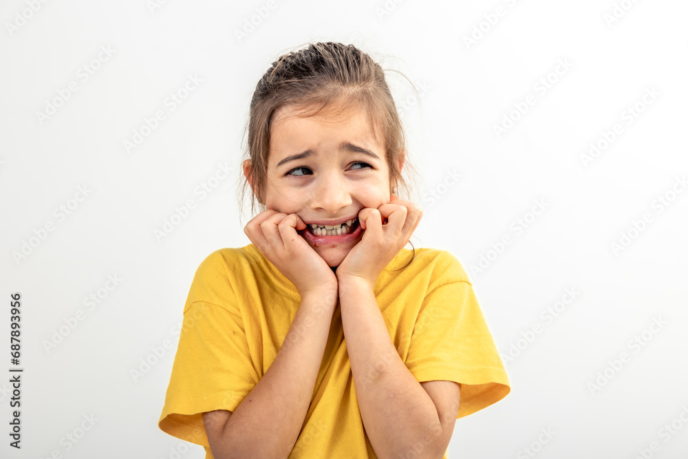 Scared and anxious girl, biting her fingernails on a white background isolated. Scared and anxious girl, biting her fingernails on a white background isolated.