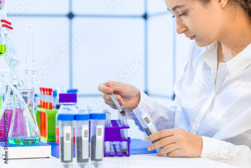  Scientist conducting medical research in laboratory with test tube.