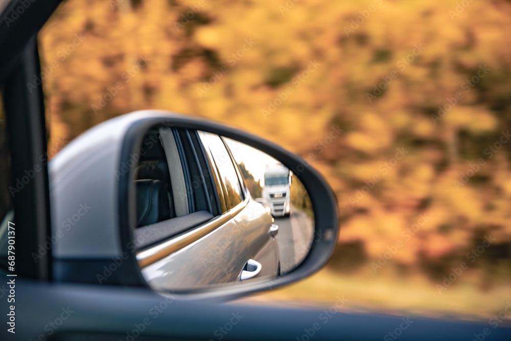 The view of the road in the car's rearview mirror.