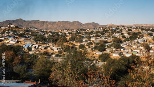 Panoramic view of Katutura township in Windhoek, Namibia, with numerous huts made of corrugated steel sheets arranged haphazardly. photo