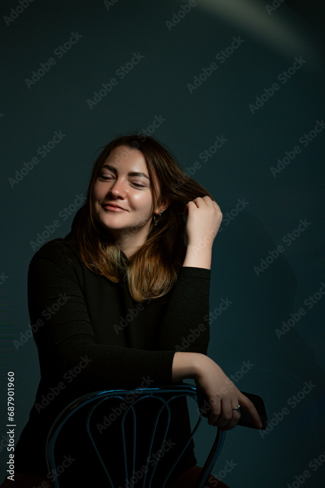 Portrait of happy caucasian businesswoman using mobile phone isolated on dark background Portrait of happy caucasian businesswoman using mobile phone isolated on dark background