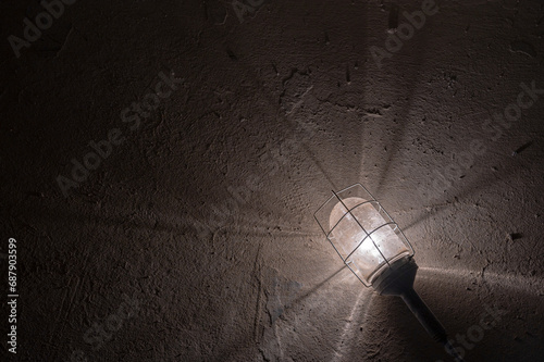 Cage Lightbulb on Concrete Floor