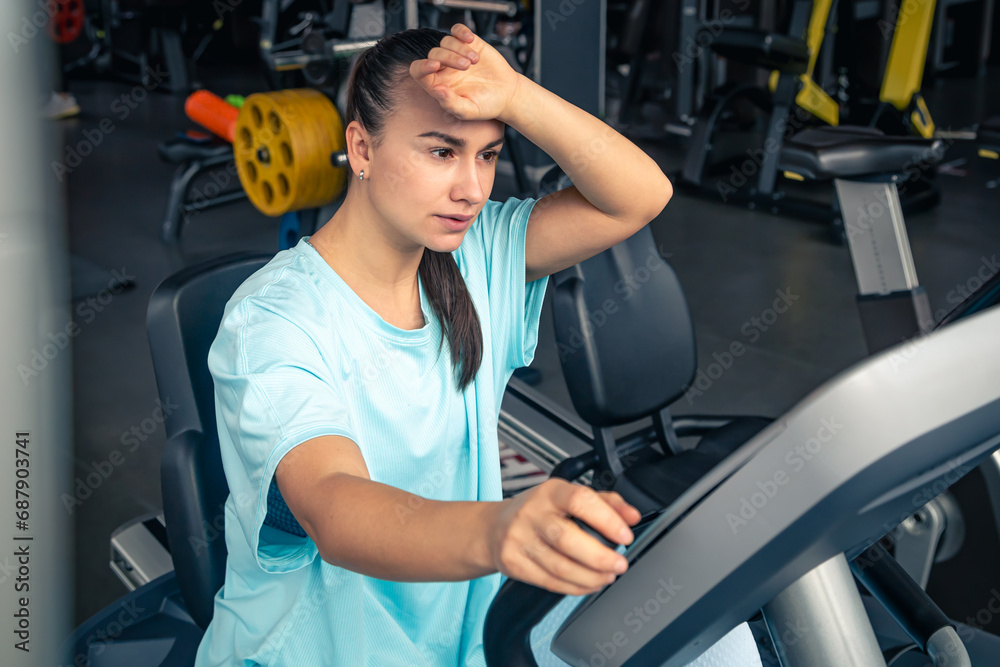 Fitness woman on bicycle doing cardio workout at gym. Fitness woman on bicycle doing cardio workout at gym.