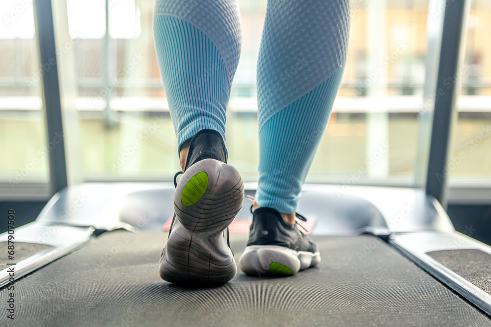 Woman's legs on a treadmill, shoes close-up, cardio workout. - obrazy, fototapety, plakaty 