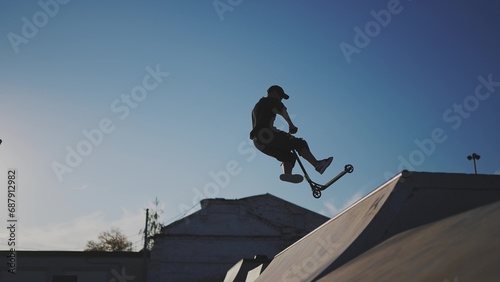 guy riding a skateboard. city landscape glare of the sun. height extreme. brave guy jumping high on a skateboard. daytime city. form content lifestyle