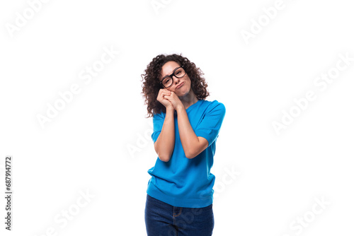 authentic slim young caucasian woman with curls dressed in a blue t-shirt and jeans
