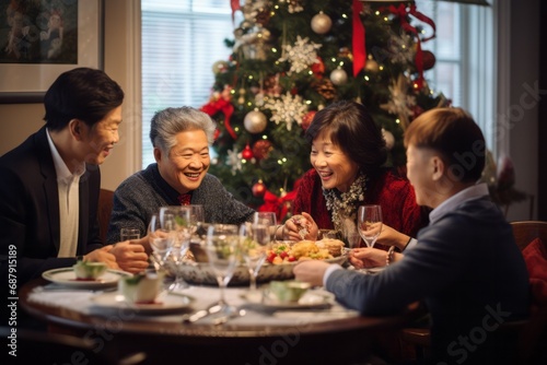 Asian family of 70 year old grand parents  40 year old parents having a Christmas lunch in daylight