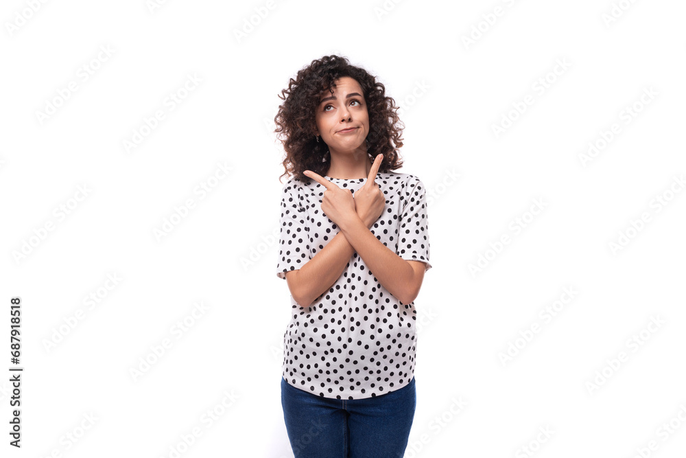 charming kind young brunette curly woman dressed in a summer blouse with a pea print actively gesticulates charming kind young brunette curly woman dressed in a summer blouse with a pea print actively gesticulates