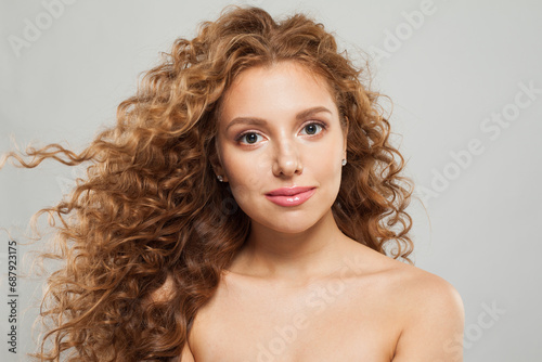 Cute woman fashion model with long wavy hairstyle, natural makeup and clear skin. Haircare, facial treatment and skincare concept