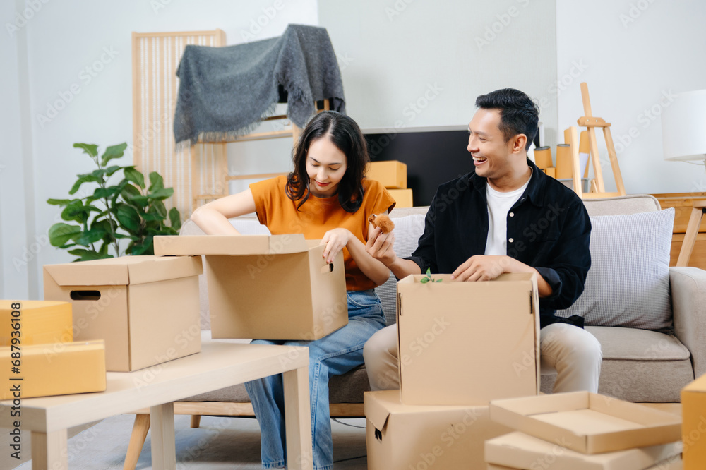 Happy asian young attractive couple man and woman with big boxes moving into a new house, new apartment for couple the new home, Moving house. Happy asian young attractive couple man and woman with big boxes moving into a new house, new apartment for couple the new home, Moving house.