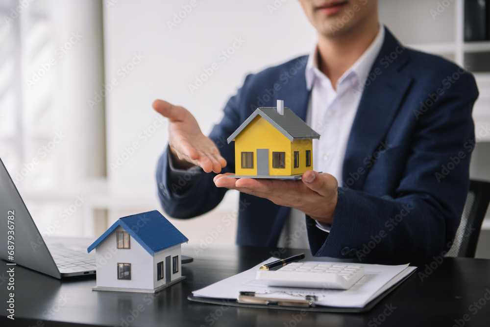 Considering buying a home, investing in real estate. Broker signs a sales agreement. agent, lease agreement, successful deal Considering buying a home, investing in real estate. Broker signs a sales agreement. agent, lease agreement, successful deal