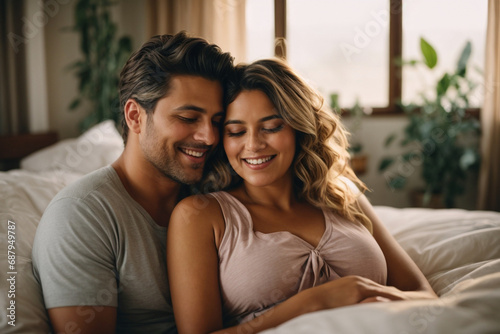 Tender portrait of relaxed pregnant couple hugged on bed with happy face expression in the morning at home. Generative AI.