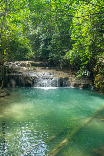 Fototapeta Naklejka Na Ścianę i Meble -  Erawan National Park in Thailand. Erawan Waterfall is a popular tourist destination and famous for its emerald blue water. Deep forest in tropical climate with fantasy atmosphere.