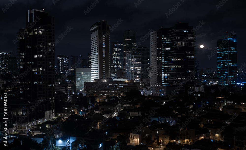 Tel Aviv modern office buildings at night. Full moon