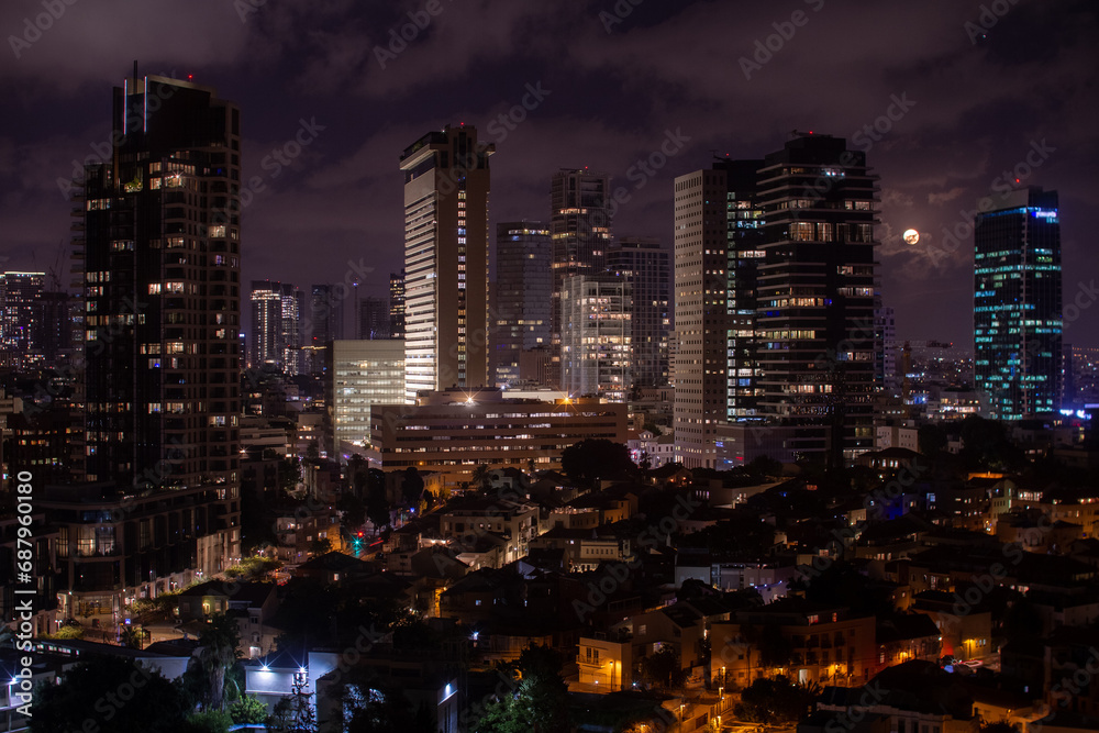 Tel Aviv modern office buildings at night. Full moon Tel Aviv modern office buildings at night. Full moon
