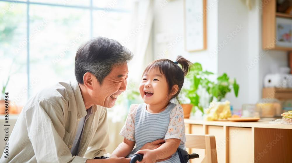 Senior Japanese man with a happy smiling child playing showing affection at home