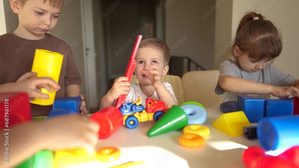 kindergarten. a group of children play toys cubes and cars on the table in kindergarten. kid dream creative happy family preschool education lifestyle concept. nursery baby toddler home