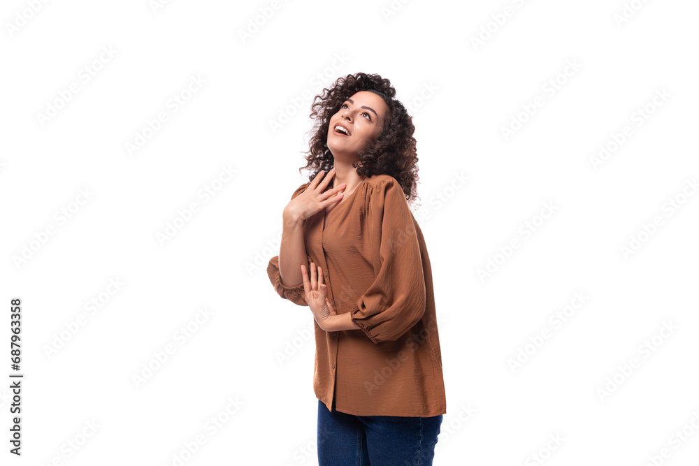 portrait of a young european curly woman with curled hair on a curling iron in a brown blouse isolated on a white background portrait of a young european curly woman with curled hair on a curling iron in a brown blouse isolated on a white background