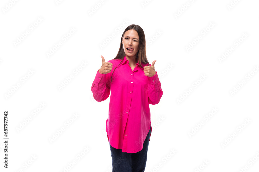 positive inspired young brunette lady dressed in a bright pink shirt and jeans on a white background positive inspired young brunette lady dressed in a bright pink shirt and jeans on a white background