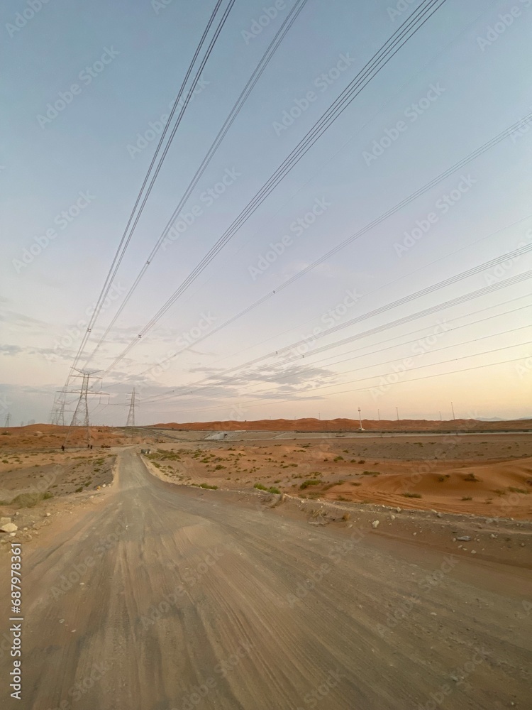 road in the desert with power lines in the background road in the desert with power lines in the background