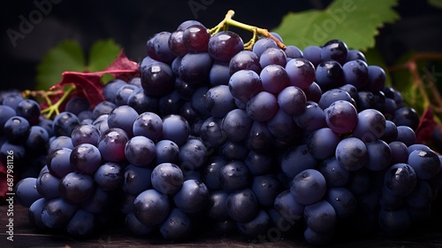 Photograph a bunch of succulent grapes, their deep purple color and plumpness on full display.