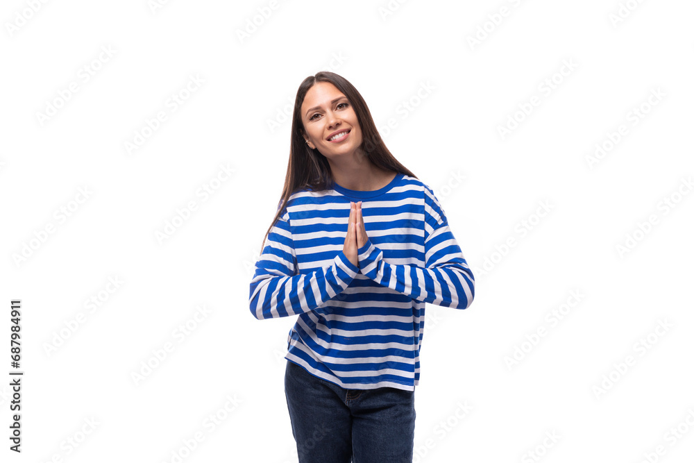young slender european brunette woman dressed in a striped blue sweater on a white background young slender european brunette woman dressed in a striped blue sweater on a white background