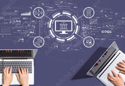 Cryptocurrency fintech theme with people working together with laptop computers photo